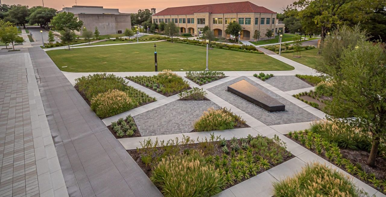 Commercial building with paved walkways and landscaped grounds