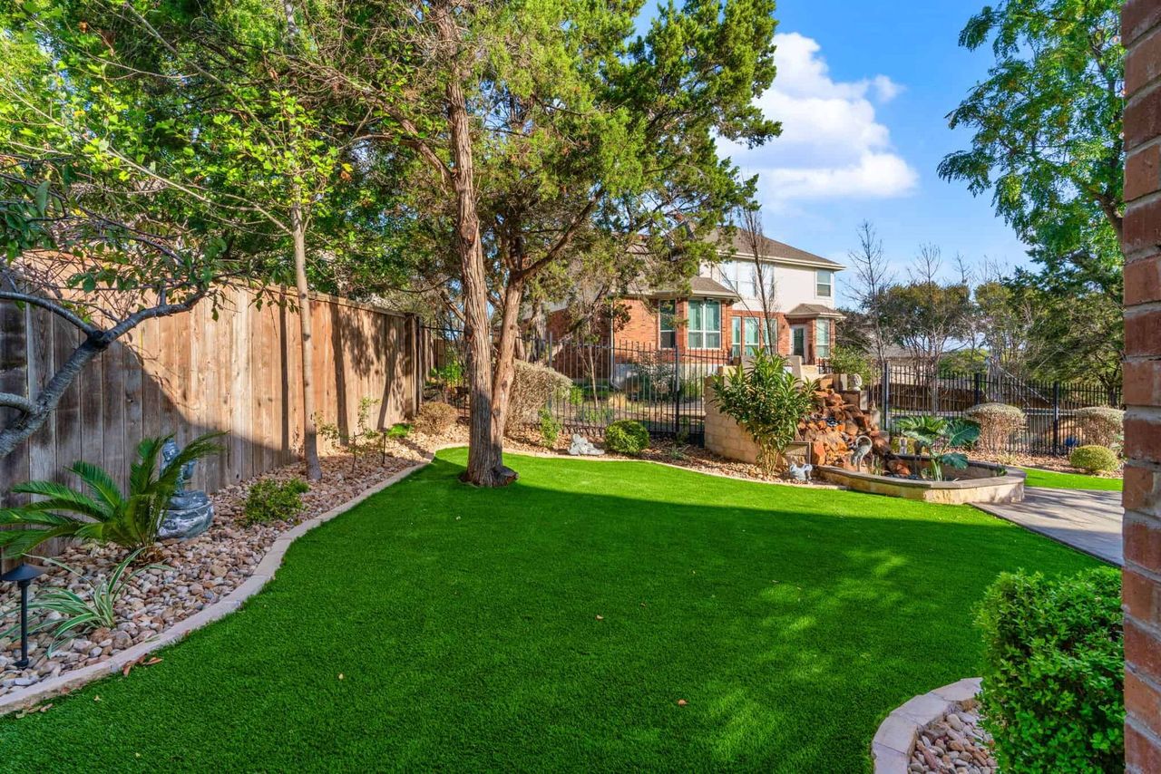 Freshly landscaped lawn with paver walkway and garden beds